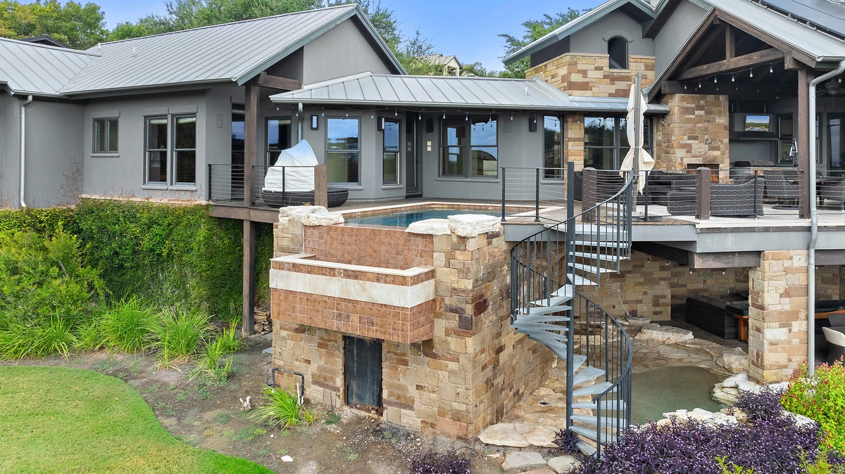 Elevated deck pool and spa with a spiral staircase