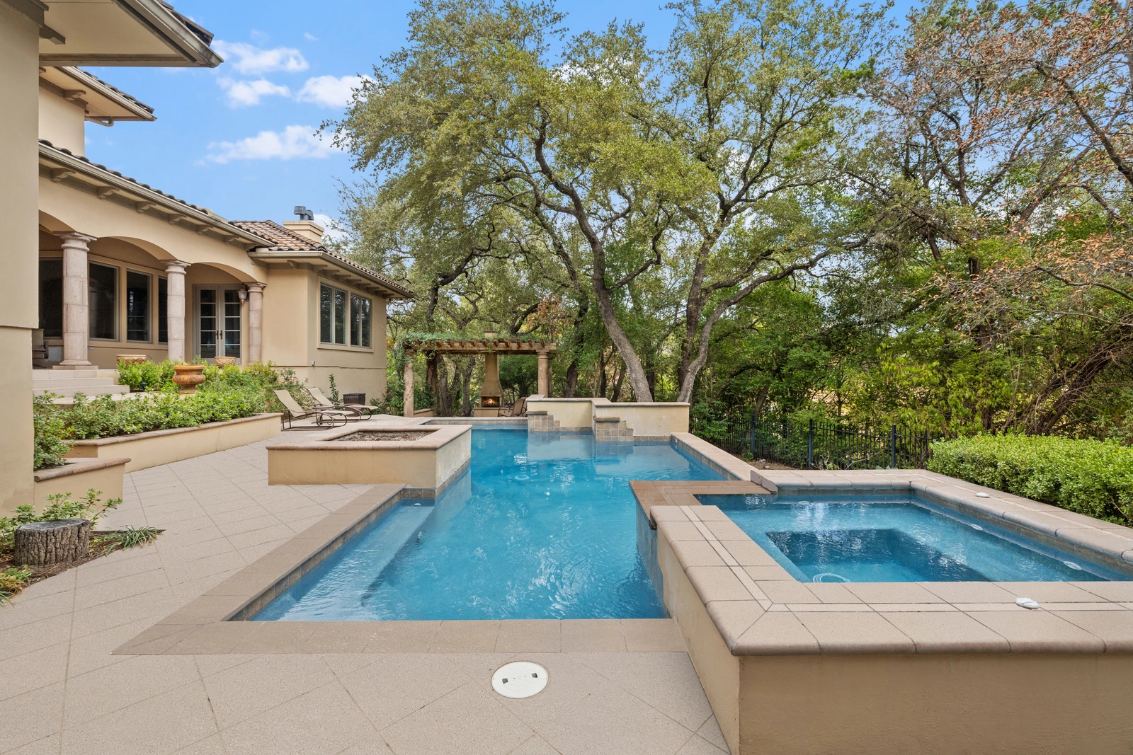 Multi-level pool and spa with tile waterfall built for an Austin backyard