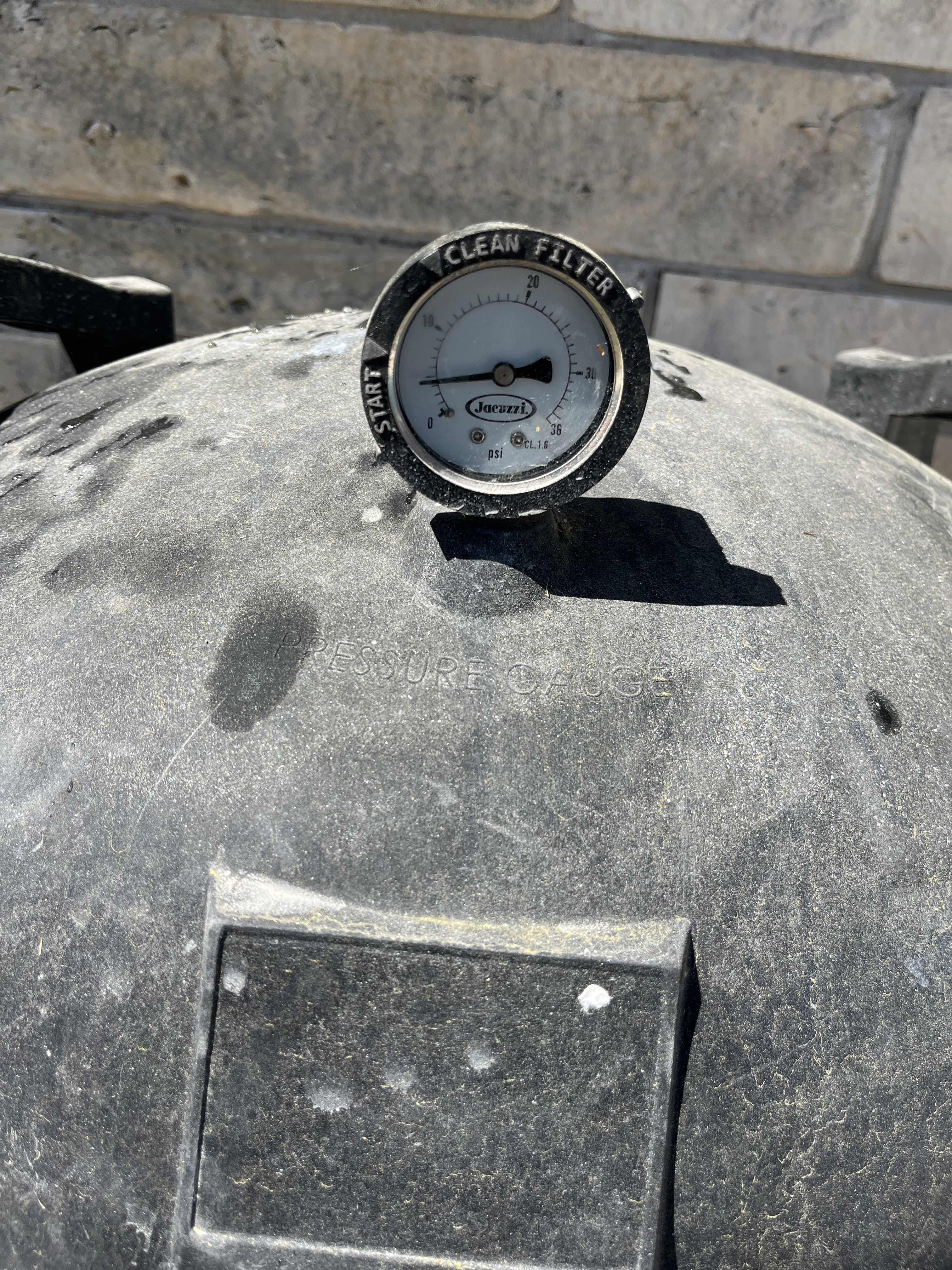 Close-up of a pool filter pressure gauge checked during a repair visit